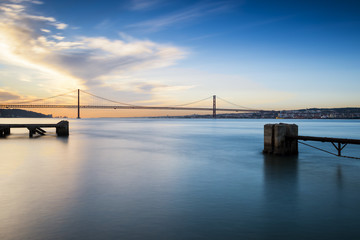 View of the bridge over the Tagus River in Lisbon, Portugal, at sunset