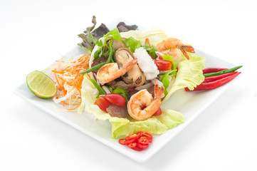 Mixed seafood with noodles and lettuce isolated on white