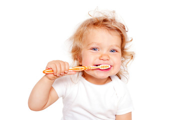 Happy baby toddler brushing teeth. Isolated on white