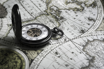 Vintage antique pocket watch on old map background