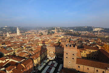Fototapeta na wymiar Roofs of houses and towers of the Italian Verona from the observation deck