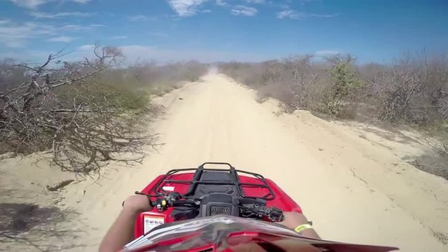First person POV of a four wheeler driving on trails at the coast