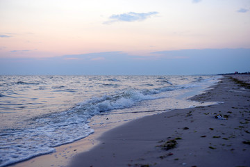 Sea shore, waves and sky at sunset