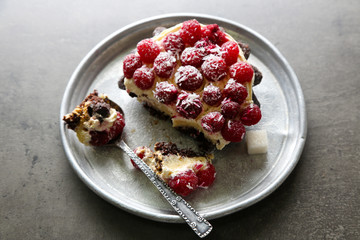 Sweet cake with raspberries on dark background