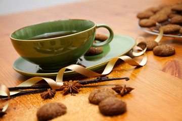 hot winter tea with ginger cookies and christmas decoration on wooden table
