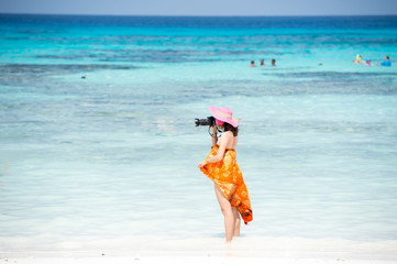 Photographer girl shooting images on koh tachai beach