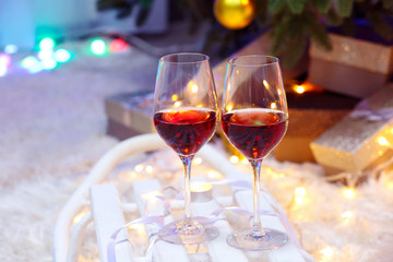 Two glasses of wine on christmas decor background