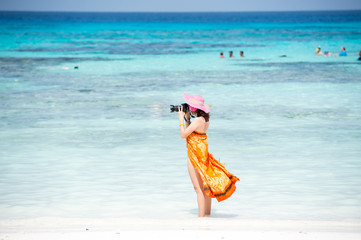 Photographer girl shooting images on koh tachai beach.