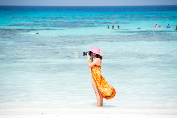 Photographer girl shooting images on koh tachai beach.