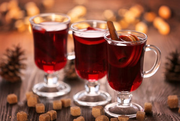 Mulled wine with sugar on wooden table
