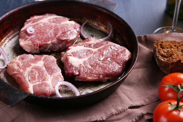Marbled beef steak on pan and spices on color wooden background