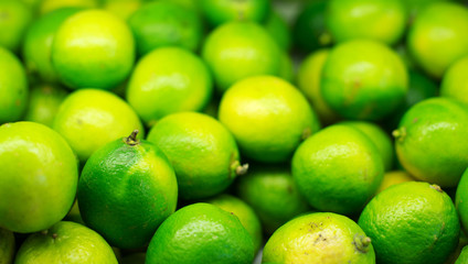 Lots of bright green limes in supermarket.
