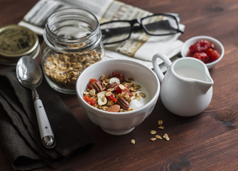 Healthy Breakfast - Greek yogurt and homemade granola on a dark wooden surface. Healthy food