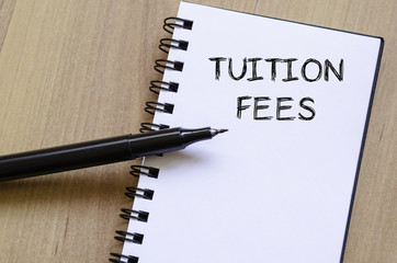 Tuition fees write on notebook - 97454631