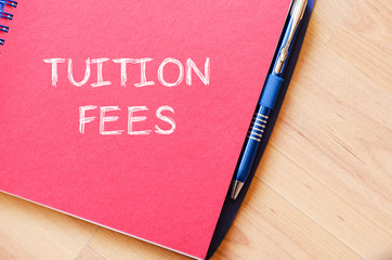 Tuition fees write on notebook