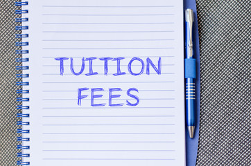 Tuition fees write on notebook