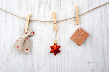 Message and red star on clothesline on vintage wooden background and space for text