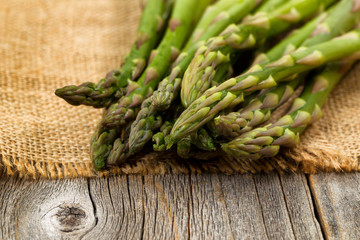Fresh Asparagus on napkin and rustic wood