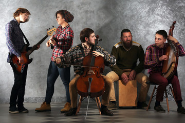 Musical band on grey wall background