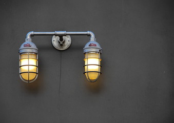 Reinforced City Lamps with Metal Grid on Dark Wall