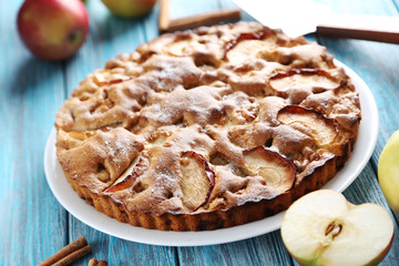Homemade apple cake on blue wooden table
