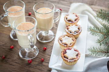 Glasses of eggnog with mince pies