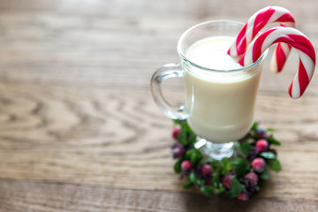 A glass of eggnog with mince pies