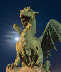 Green dragon on Dragon bridge in Ljubljana with super-moon
