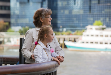 Little girl and grandmother walking through the bridge and enjoying the view City of London