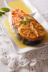 Salmon steak grilled with orange and mint decorated. vertical
