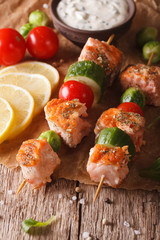Grilled salmon on skewers and tartar sauce close-up. vertical
