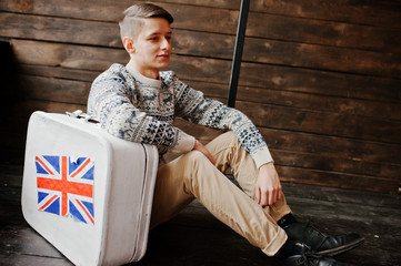 Young fashion man with the suitcase with the British flag
