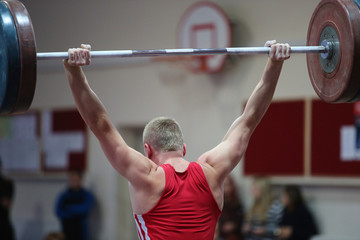 Fototapeta premium athlete in his attempt to lift the weights