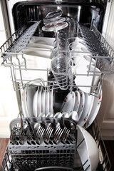 Open dishwasher with clean utensils