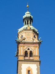 Fototapeta na wymiar Hall in Tirol, Heart of Jesus church tower bell with blu skt background, vertical frame.