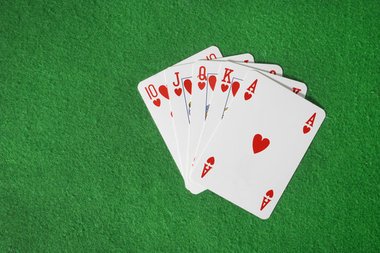 Playing cards isolated on green background
