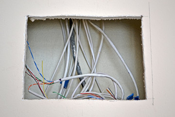 internet cables heap in square hole under wall, power outage, industry divewrsity