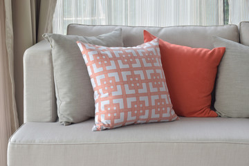 Chinese pattern in orange with deep orange and gray pillows on l