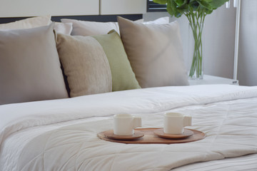 wooden tray of tea set on bed in modern bedroom interior