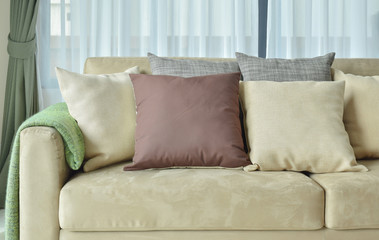 Brown pillows on light brown leather sofa
