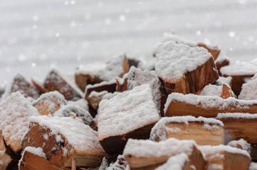 snow falling on warming wood