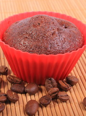 Fresh baked chocolate muffins and coffee grains