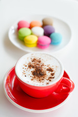 Cup of hot coffee and macaroons