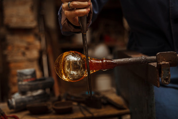 Glass Artist in her workshop making glassware - 97475816