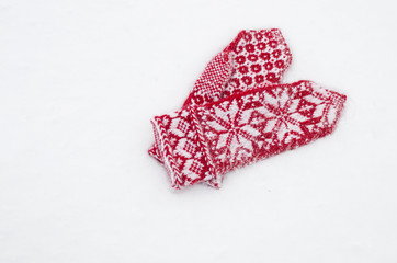red mittens on white snow  