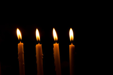 frame light candle burning brightly in the black background