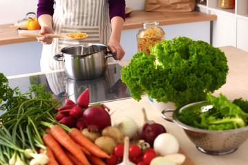 Young Woman Cooking in the kitchen. Healthy Food