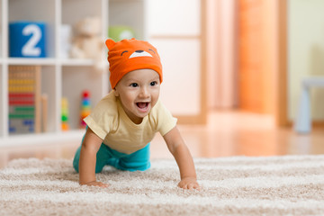 crawling kid or child at home on carpet