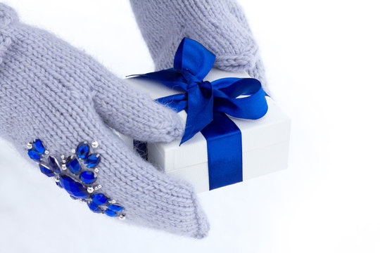 gift in a box with a blue ribbon