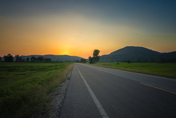 Sunset road at mountains